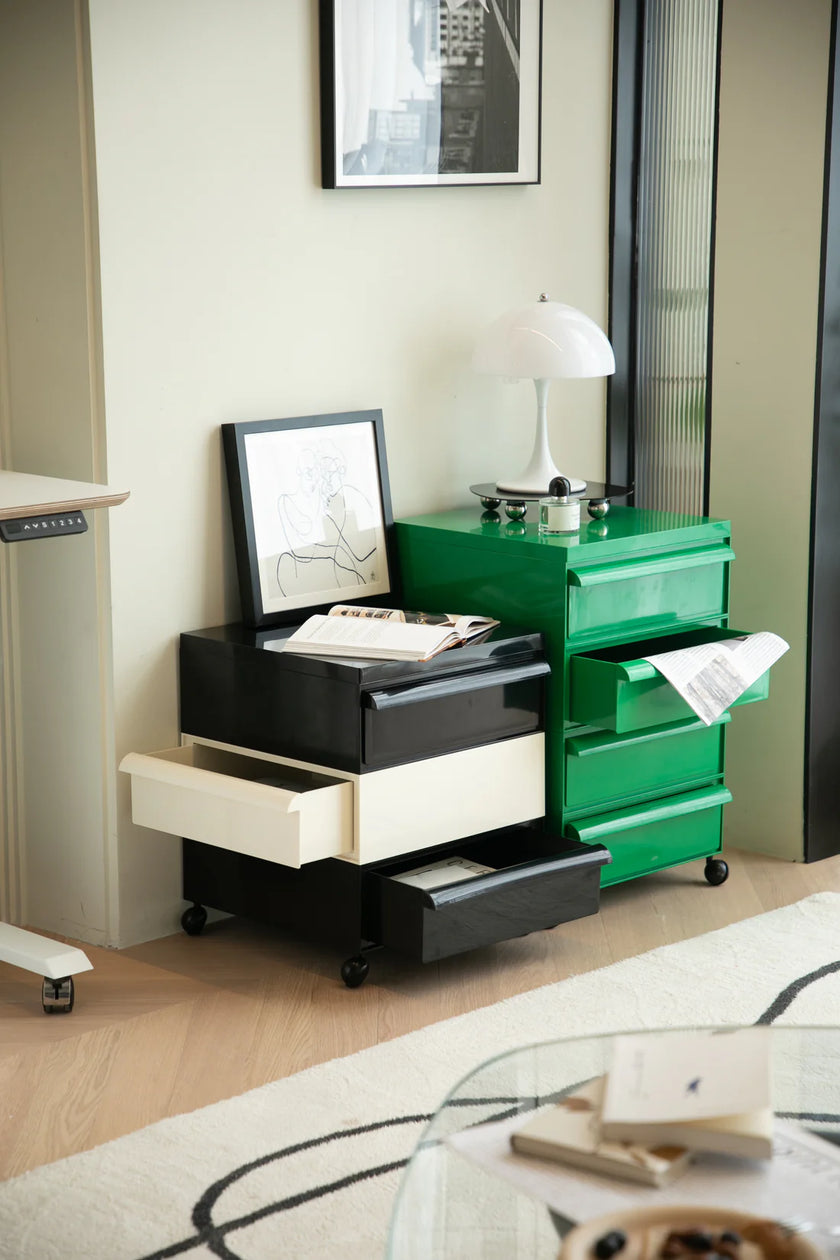 Modern bedroom with green and black file cabinet, framed picture, and lamp.