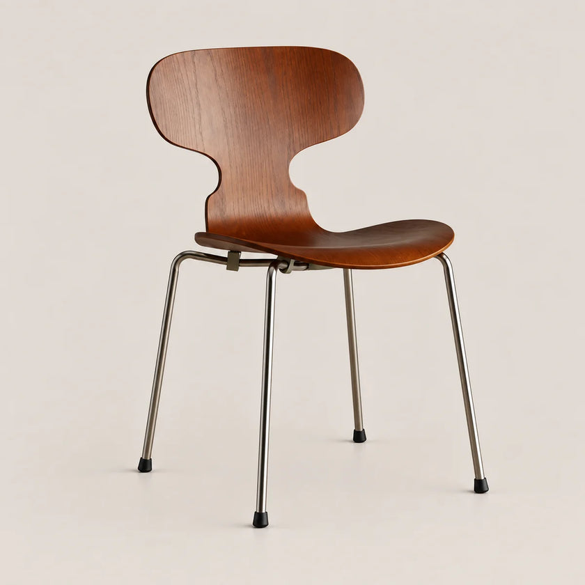 A mid-century modern dining chair with a curved wooden seat and backrest on slim metal legs, shown against a plain light beige background.
