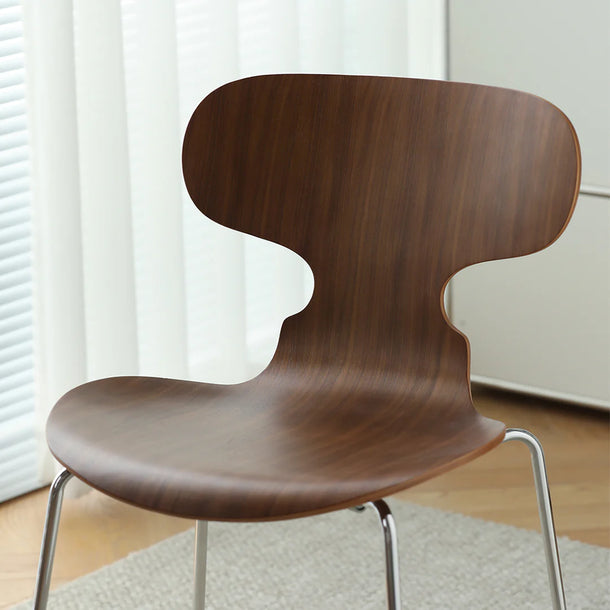 Wooden chair with metal legs on a light-colored rug