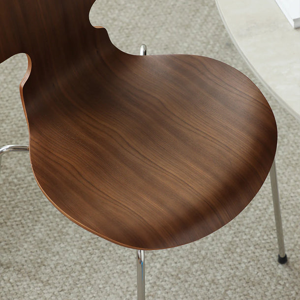 Wooden chair seat on a textured floor