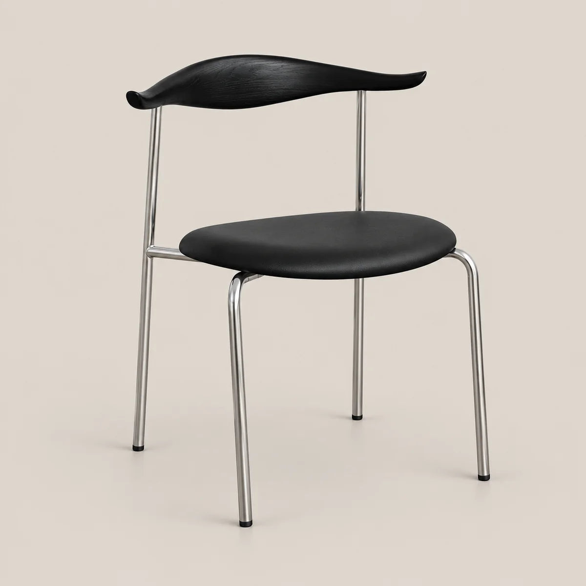 A modern dining chair with a black molded seat and curved backrest, supported by slim chrome metal legs, shown against a solid light beige background.