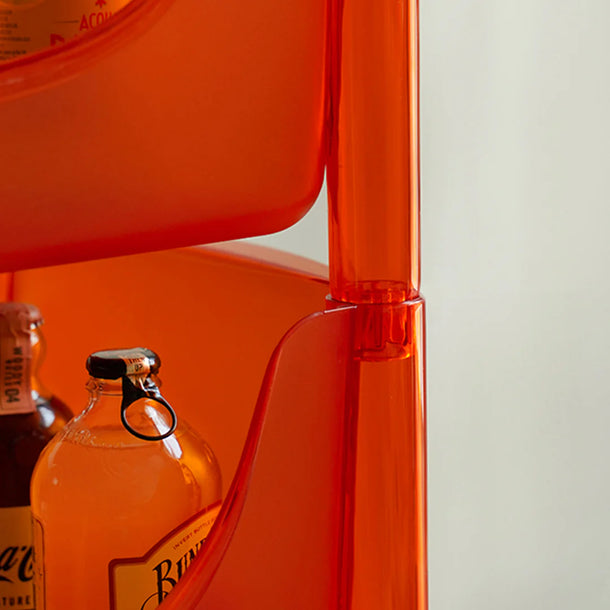 Close-up of an orange chair with a bottle of Johnnie Walker Blue Label whisky on a white background