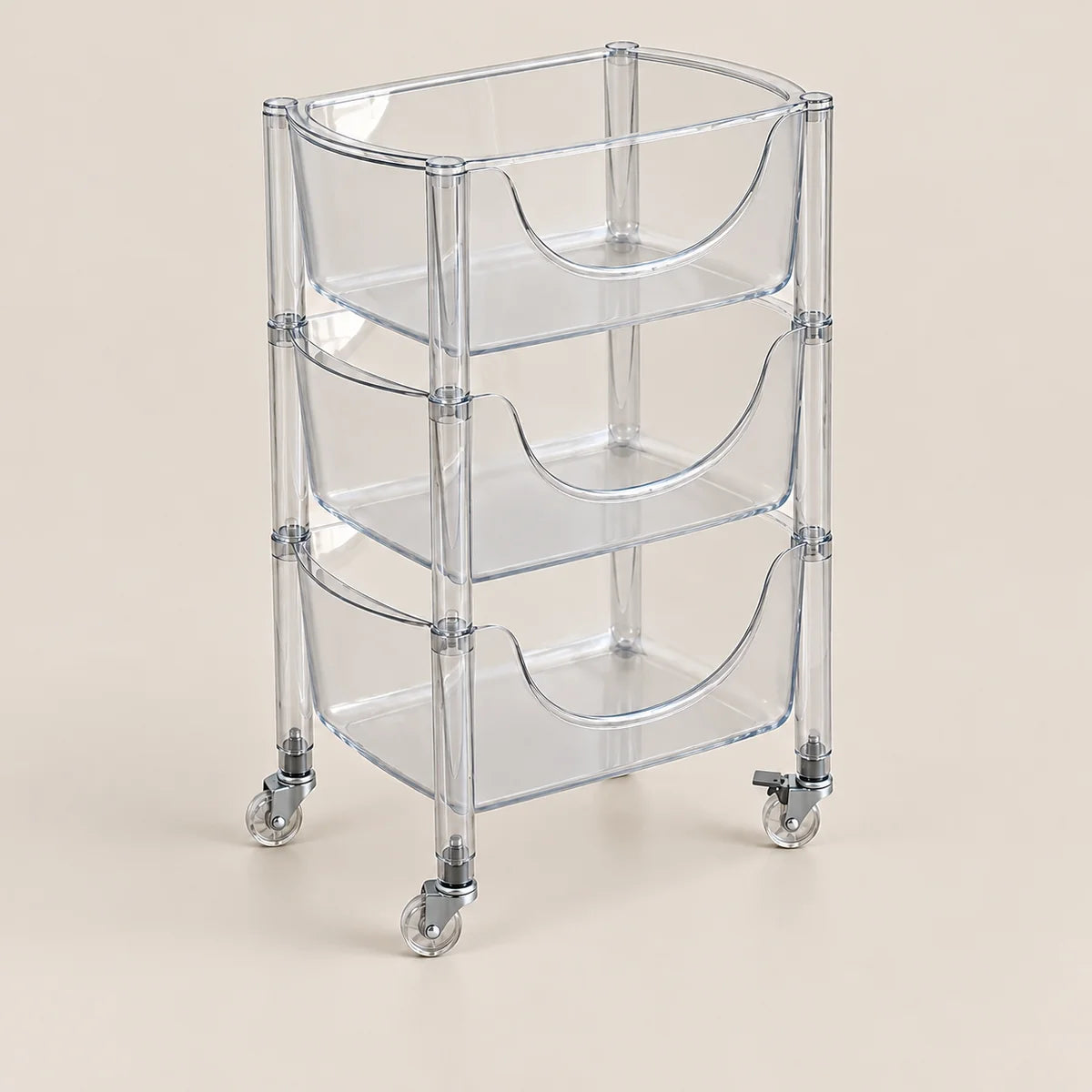 A three-tier clear acrylic rolling storage cart with integrated handles and caster wheels, shown on a solid beige background.
