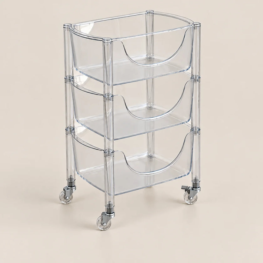 A three-tier clear acrylic rolling storage cart with integrated handles and caster wheels, shown on a solid beige background.