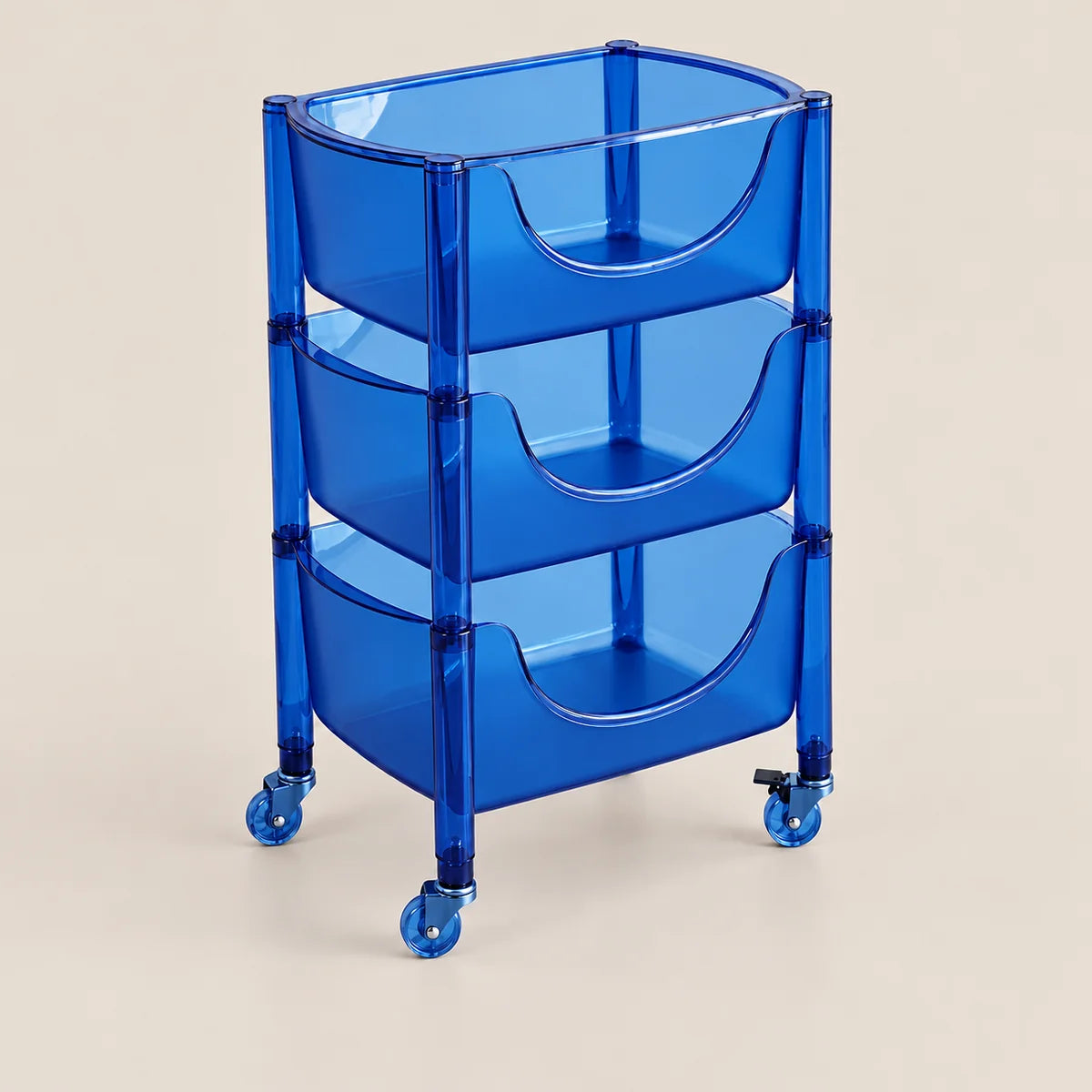 A translucent blue three-tier rolling storage cart with curved pull-out bins and casters, shown on a plain light beige studio background.