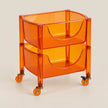 An orange translucent plastic rolling storage cart with two tiered baskets and caster wheels, shown on a light beige background.