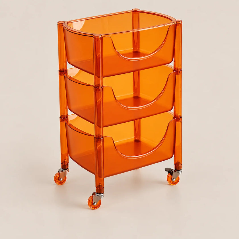 An orange translucent plastic rolling storage cart with three tiered baskets and caster wheels, shown on a light beige background.