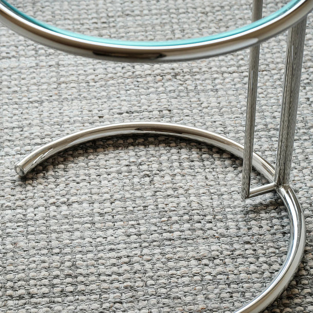 Close-up of a metallic circular object on a textured gray surface