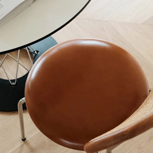 Brown chair seat on a wooden chair with a blurred background