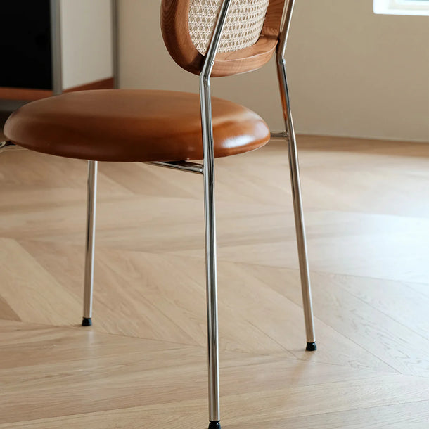 Brown chair with metal legs on a wooden floor