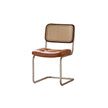 Brown leather chair with wicker backrest on a white background