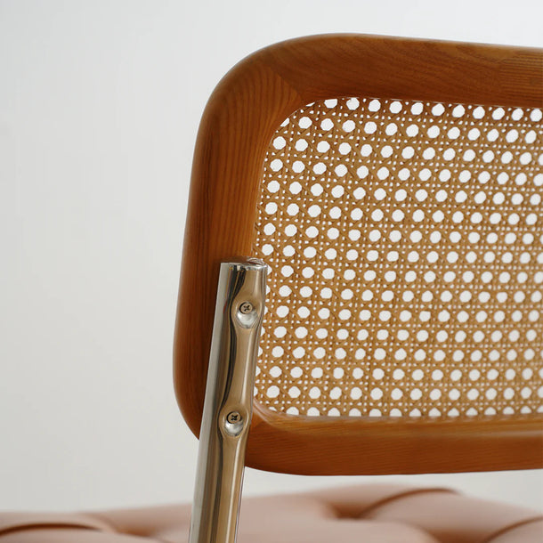 Wooden chair with a metal clip on a neutral background