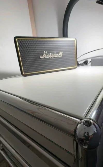 Marshall speaker on a white surface with a blurred background