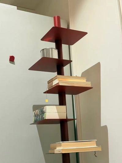 Modern bookshelf with books against a white wall
