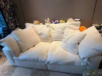 White sofa with decorative pillows in a room setting