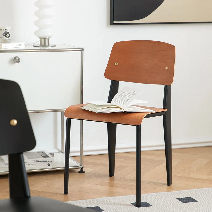 Wooden chair with black legs in a room setting