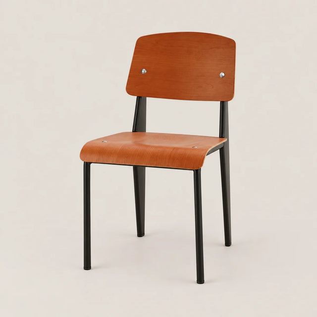A modern wooden chair with a warm orange-brown wood grain seat and backrest, supported by slim black metal legs, photographed against a neutral light beige background.