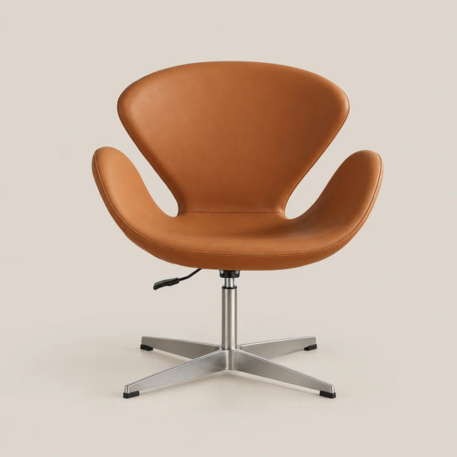 A modern swivel lounge chair with a warm tan leather shell and a silver metal four-star base, photographed against a solid light beige background.
