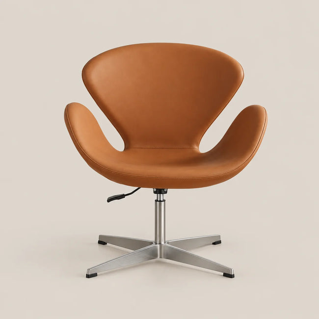 A modern swivel lounge chair with a warm tan leather shell and a silver metal four-star base, photographed against a solid light beige background.