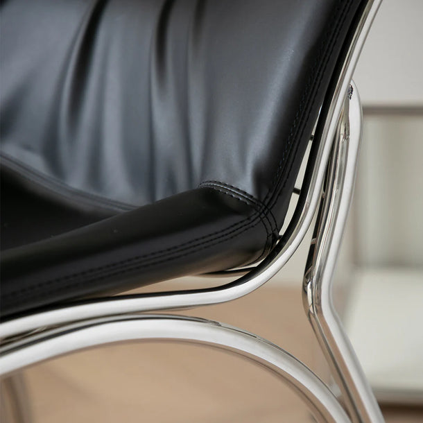Close-up of a black leather chair with chrome frame