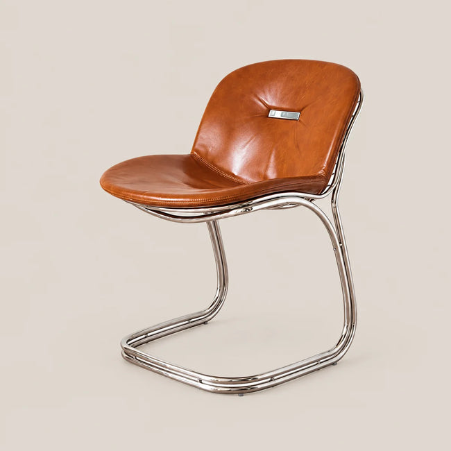 A mid-century modern side chair with a curved cognac brown leather seat and backrest, supported by a polished chrome cantilevered metal base, set against a solid light beige background.