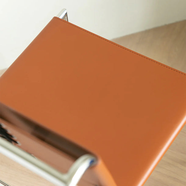 Close-up of an orange folder on a wooden surface