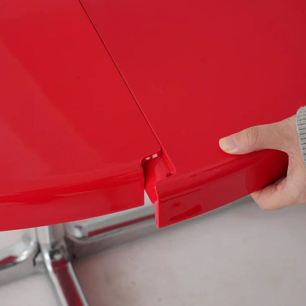 Red metal box with a hand opening it on a gray surface