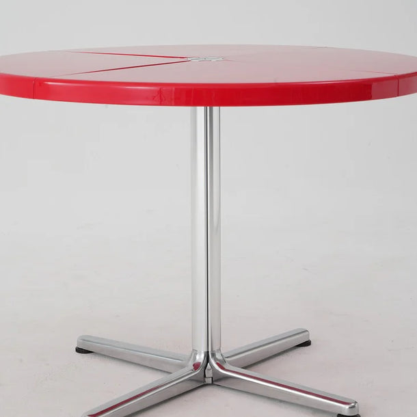 Red round table with a chrome base on a white background