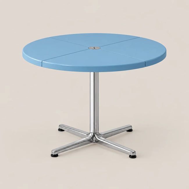 A round light blue table with a segmented top and a chrome star base, shown on a solid beige background.