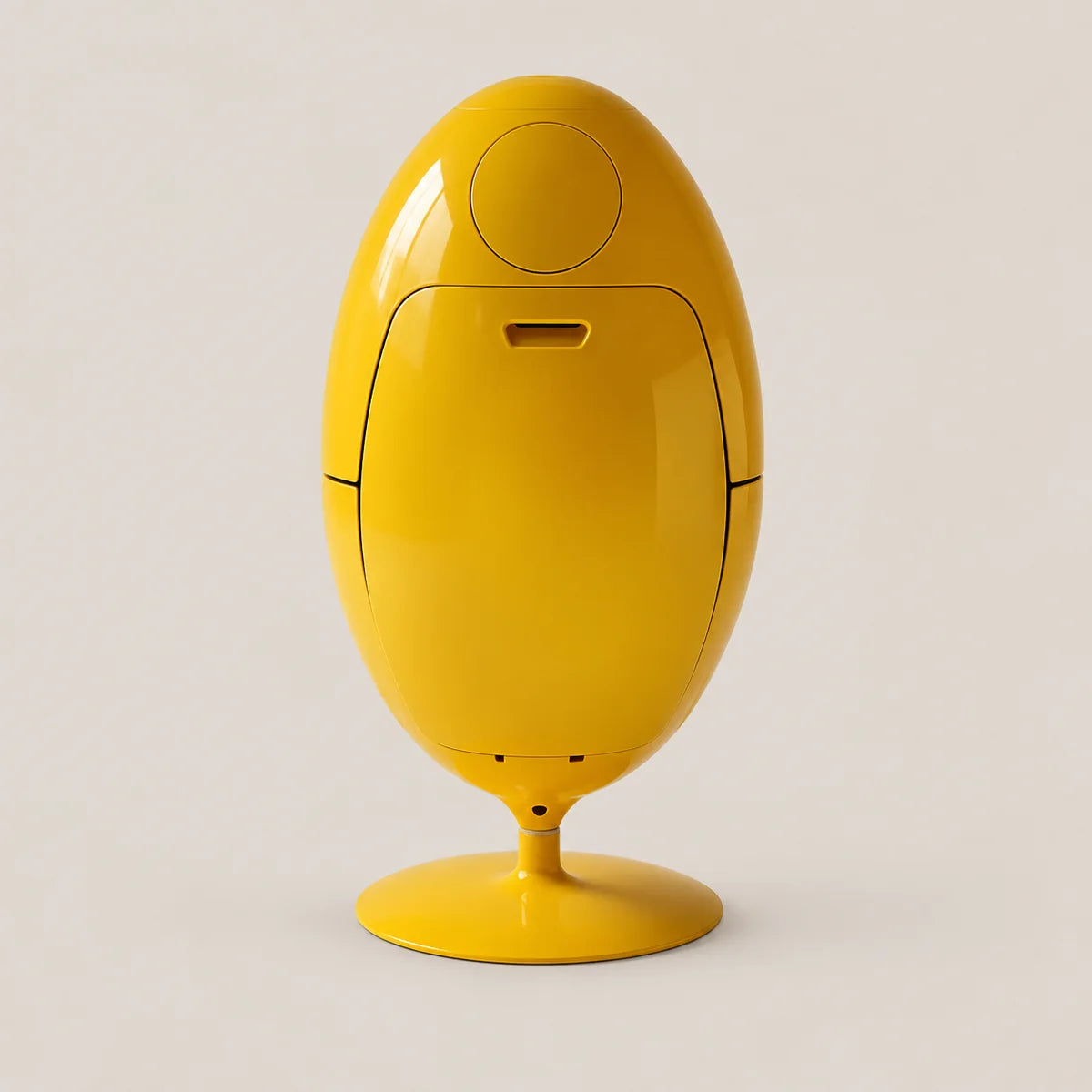 A bright yellow egg-shaped electronic device with a glossy finish, standing on a matching yellow pedestal base against a light beige background.