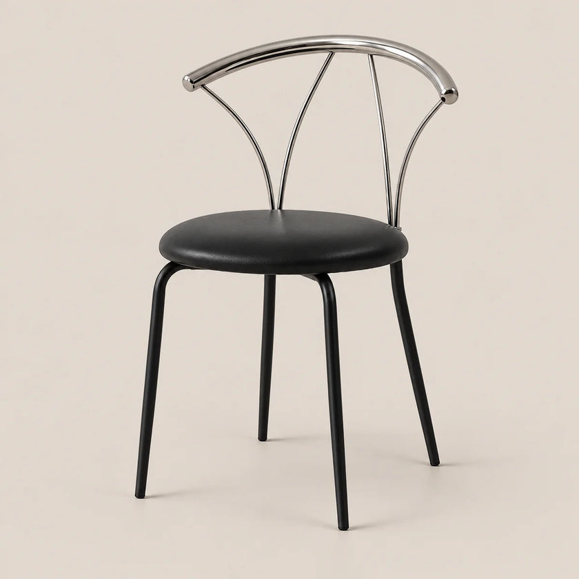 A modern dining chair with a black upholstered seat and black legs, featuring a curved polished silver metal backrest, set against a solid light beige background.