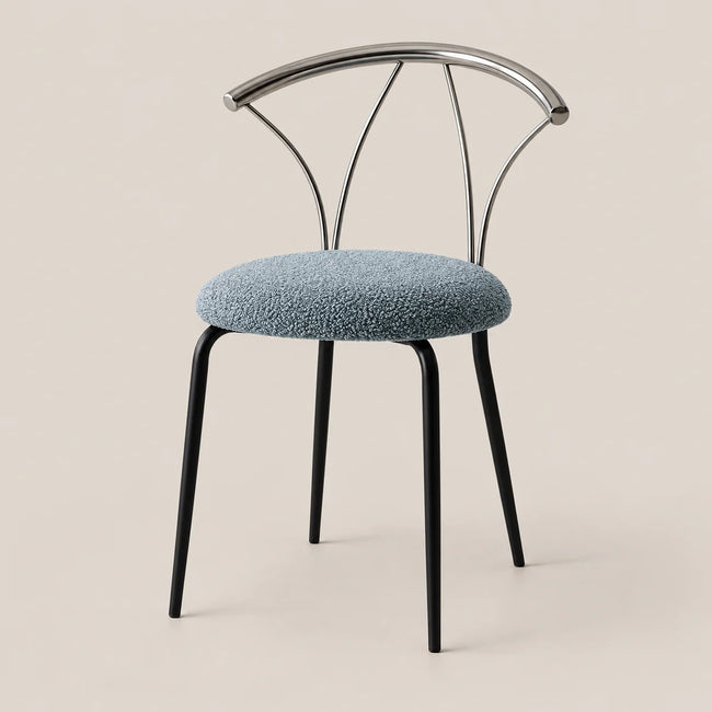 A modern dining chair with a textured light blue boucle upholstered seat, black metal legs, and a curved chrome wire backrest, set against a solid beige background.
