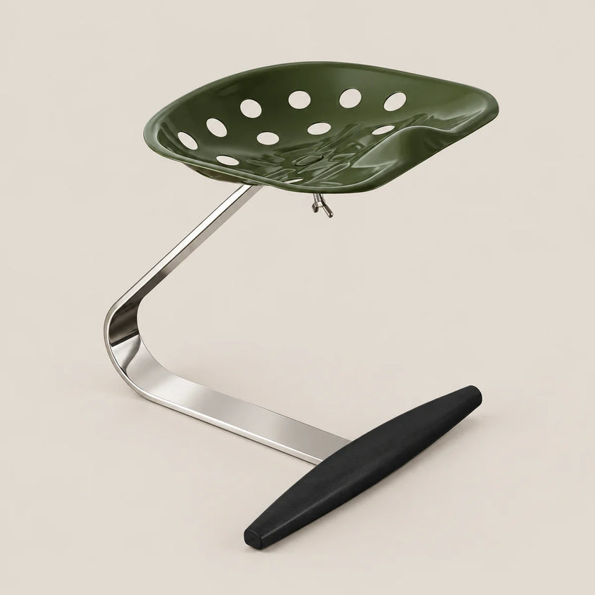 A modern industrial stool featuring a dark olive green perforated seat, a curved polished silver metal base, and a black footrest, set against a solid light beige background.