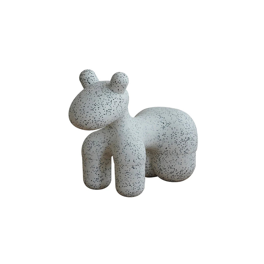 Speckled gray sculpture of a bear on a white background