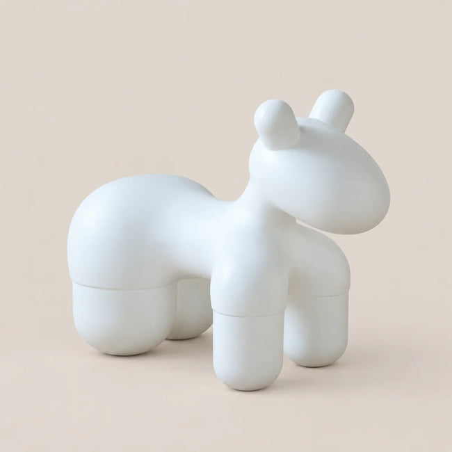 A minimalist, stylized white animal-shaped container or sculpture with rounded geometric edges, shown on a solid light beige background.