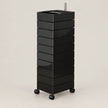 A black rolling storage cart with multiple stacked drawers and a metal handle, shown on a plain light beige studio background.