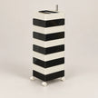 A modern black and white striped rolling storage cabinet with a top tray and small metal handle, shown on a neutral light gray background.