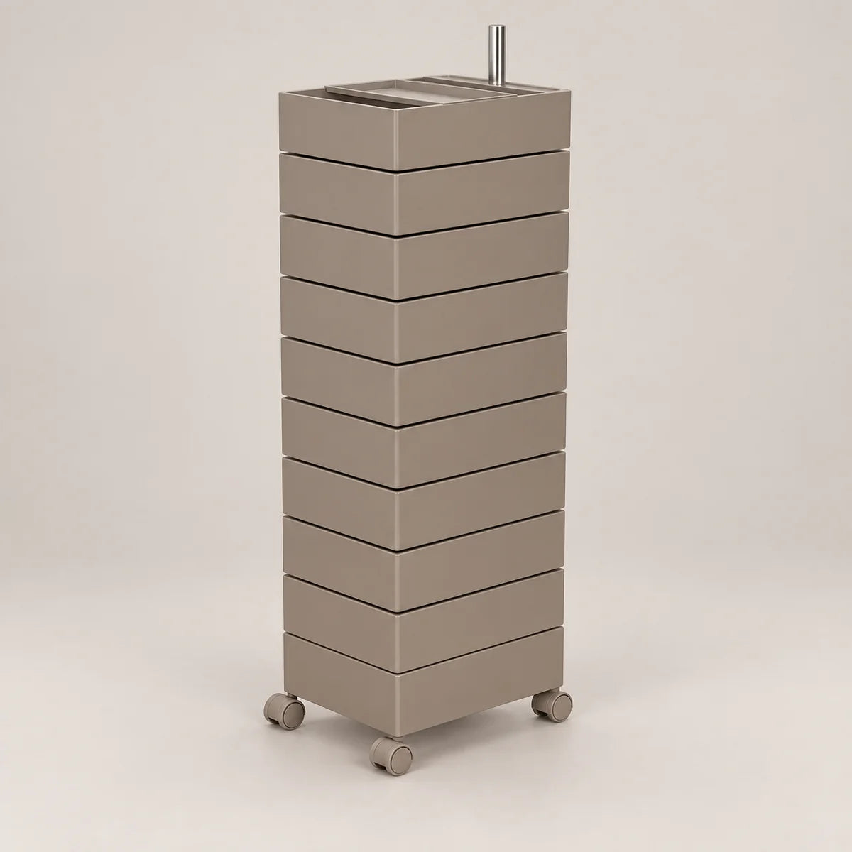 A tall, modern rolling storage cabinet with nine stacked drawers in a warm taupe-beige finish, featuring a metal top tray and four caster wheels, shown against a neutral light gray background.