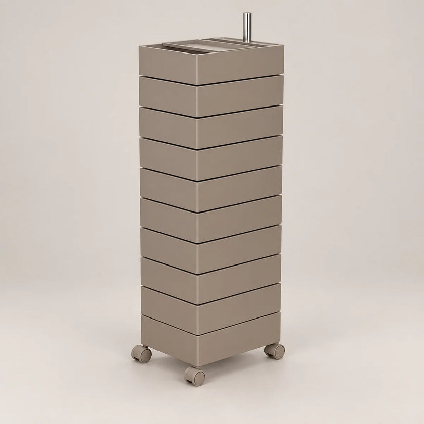 A tall, modern rolling storage cabinet with nine stacked drawers in a warm taupe-beige finish, featuring a metal top tray and four caster wheels, shown against a neutral light gray background.