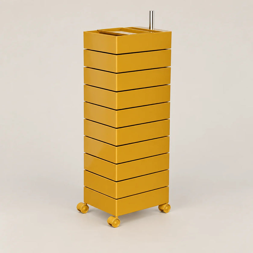 A modern mustard yellow rolling storage cabinet with eight stacked drawers and a metal rod on top, set against a plain light gray background.