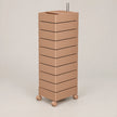 A modern, minimalist rolling storage cabinet with ten stacked rectangular drawers in a warm taupe-brown finish, featuring a built-in top tray and dual metal handles, set against a solid light beige background.