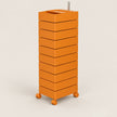 An orange modular storage cart with nine stacked drawers and four caster wheels, featuring a metal handle on top, shown against a light beige background.