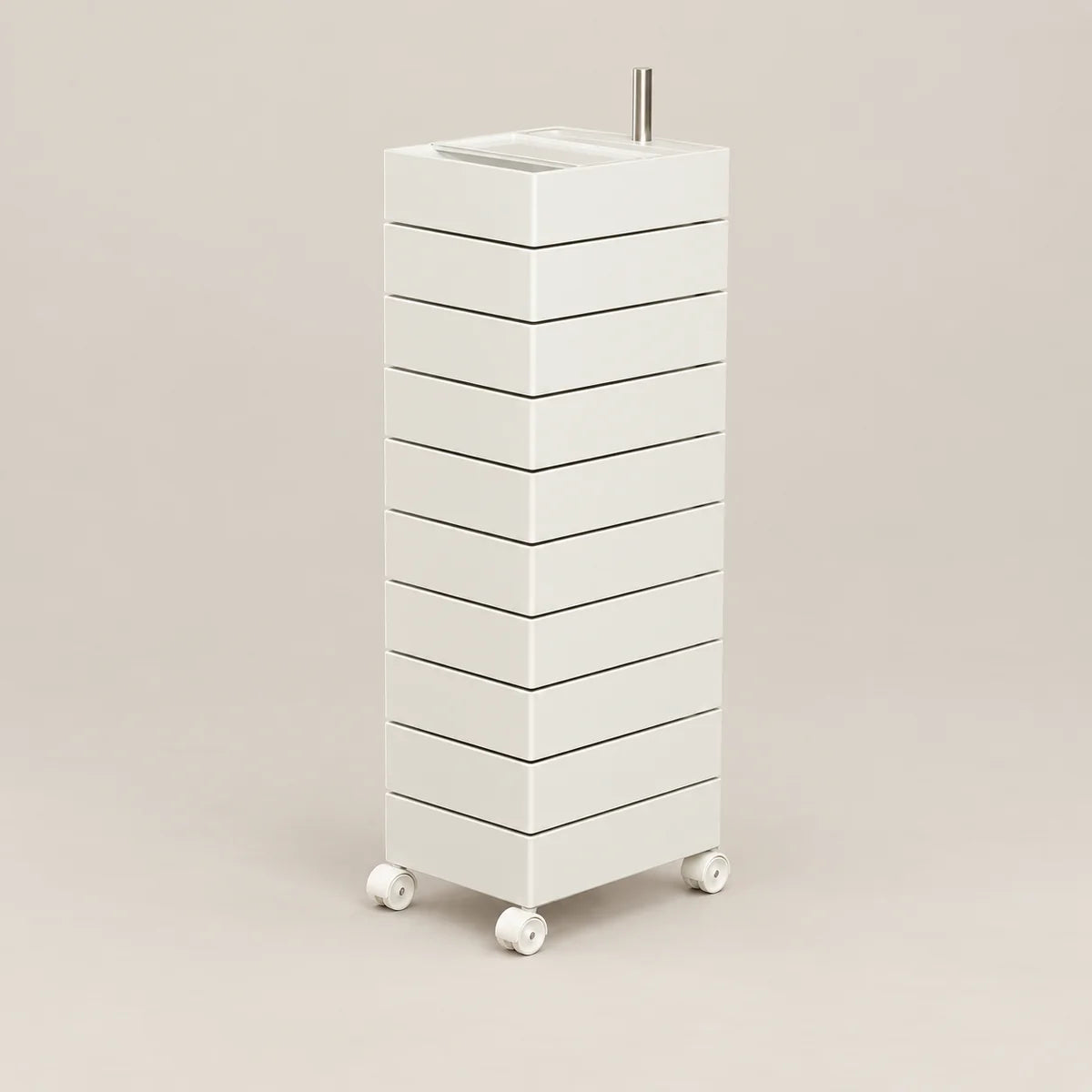 A tall, narrow white rolling storage cabinet with multiple drawers and a small metal handle on top, shown on a plain warm beige studio background.