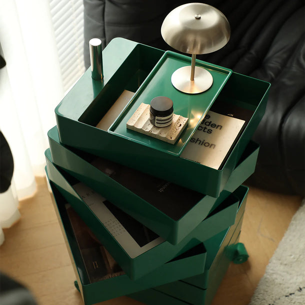 Green storage unit with various items on a wooden floor.