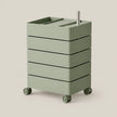 A sage green rolling storage cart with five drawers and a top organizer tray, shown on a plain light beige background.