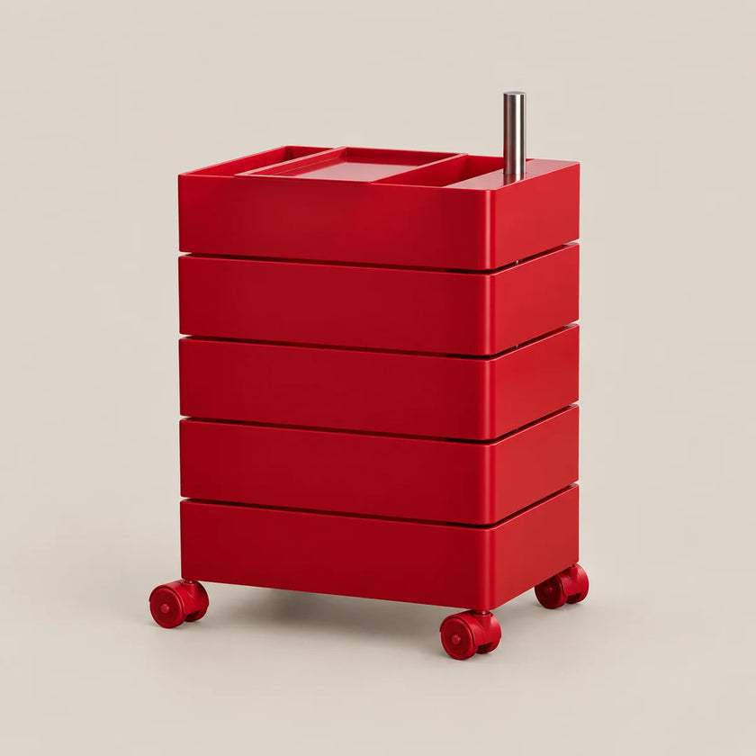 A bright red rolling storage cart with five stacked drawers, a top tray, a vertical metal handle, and small caster wheels, shown on a plain warm light gray studio background.