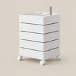 A white rolling storage cart with five drawers and a metal stand on top, shown on a plain beige background.