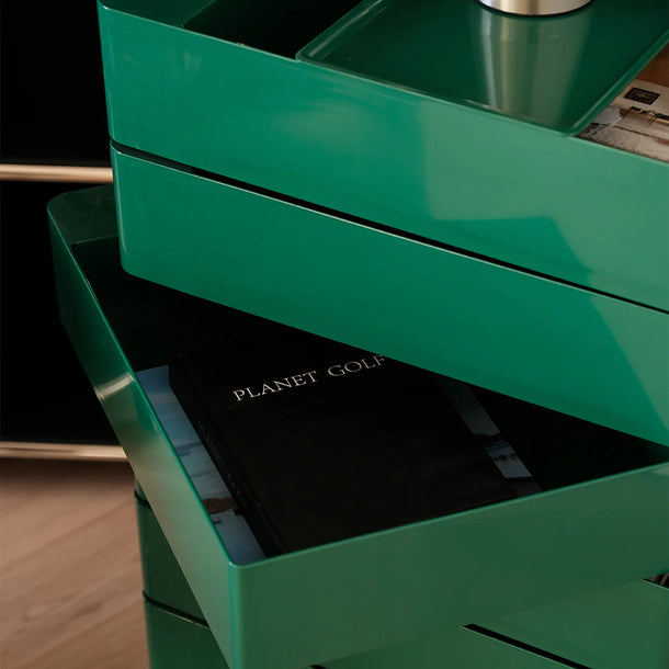 Green storage drawers with a black book titled 'Planet Golf' on top.