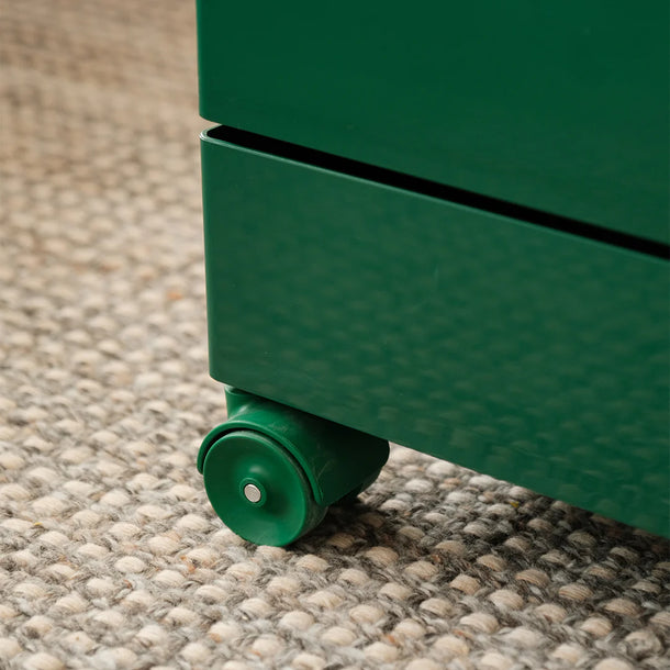 Close-up of a green wheel on a textured surface