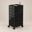 A black 6-drawer rolling storage cart with a glossy finish, featuring a metal handle on top and black caster wheels, set against a solid beige background.